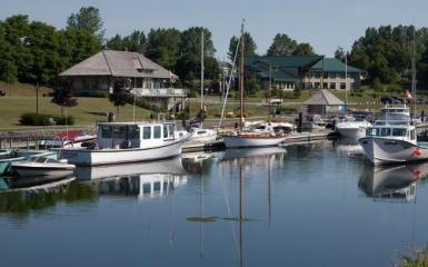 A photo of boats in a marina on calm water.
